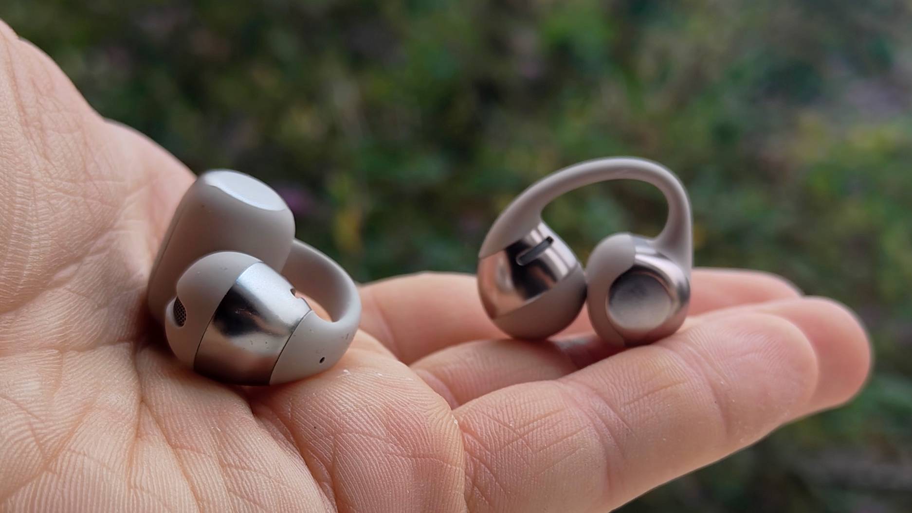 The Shokz OpenDots One in a man's hand.